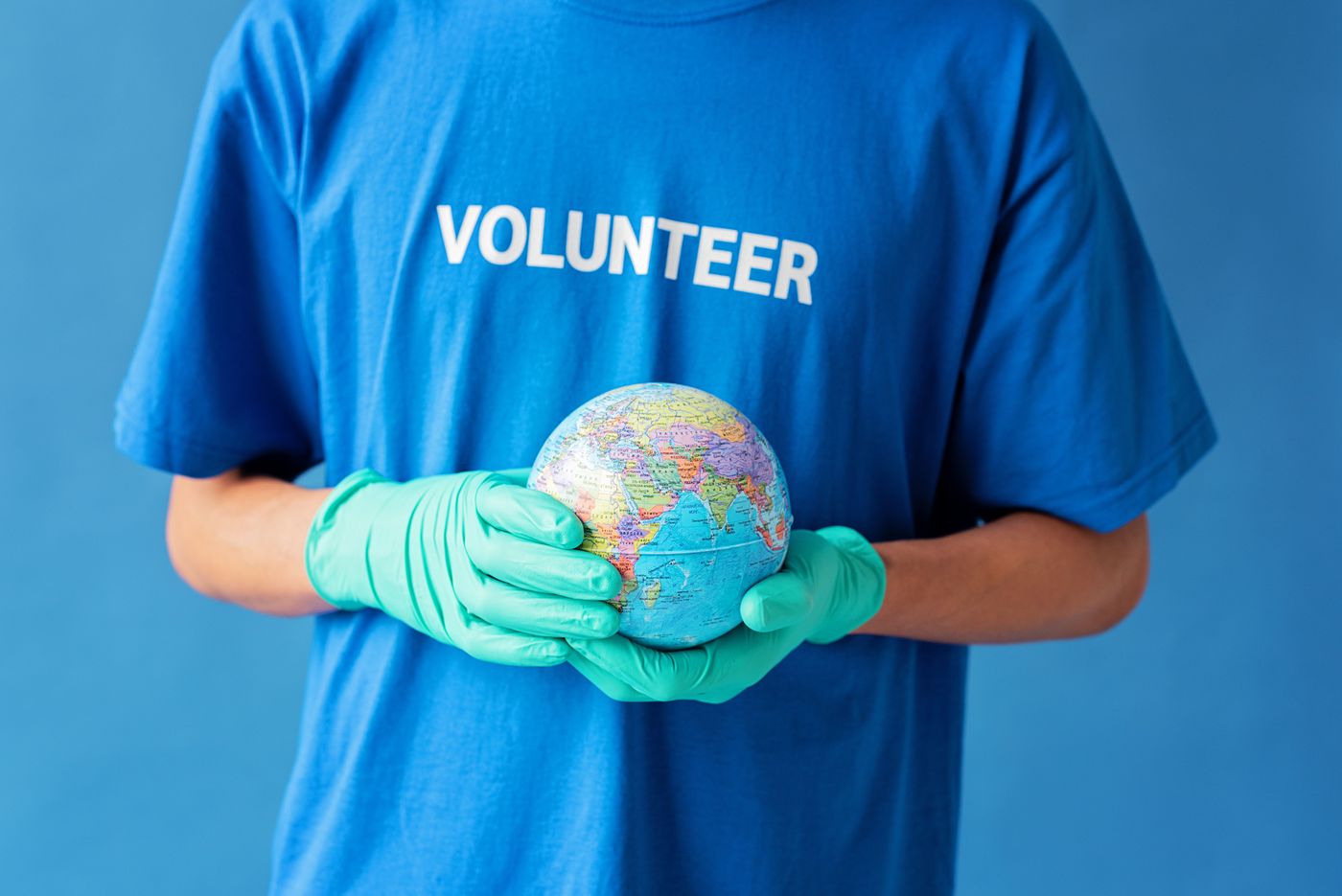 Illustrative photo: a volunteer holding a globe